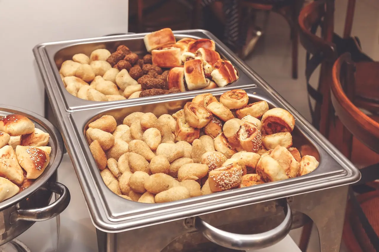 Catering trays of assorted pastries set out on a service table